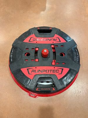 a close up of a red and black circular device on a table