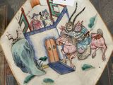 a plate with a picture of a man riding a horse