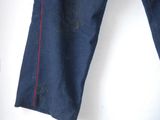 denim pants with red stitching on the side of the pants