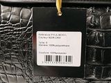 a black purse with a price tag attached to it