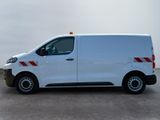 the white van is parked in a parking lot on a cloudy day