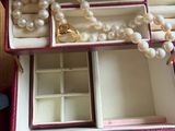 a jewelry box that has a bunch of pearls in it