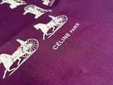 a close up of a purple shirt with a horse drawn carriage on it