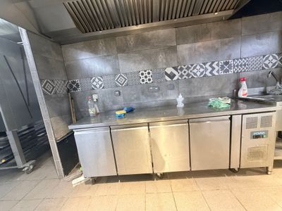 une grande cuisine équipée d'appareils électroménagers en acier inoxydable