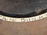 a close up of a metal object with writing on it