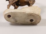 a statue of a horse on top of a rock
