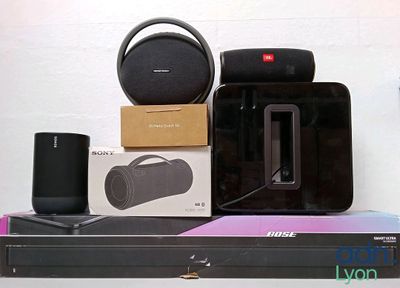 a box of speakers and a speaker on top of a shelf