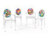three clear chairs with colorful plates on them sitting next to each other