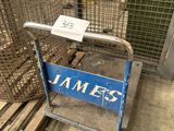 a blue sign that says jamez on it in front of a cage