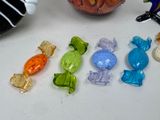a lot of candy on the table next to a vase