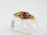a gold ring with a pink stone on top of it