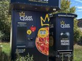 two vending machines that have pizzas on them