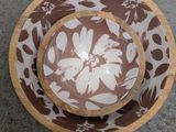 two plates and a bowl sitting on a table