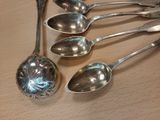 five spoons that are sitting on a table