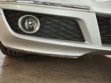 a close up of a car ' s front bumper and headlight
