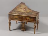 a small wooden table with a painting on it