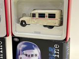 two boxes with a model of a bus inside of them