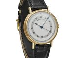 a close up of a wrist watch with roman numerals on it