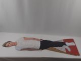 a picture of a man laying on a bed with a kite in the background