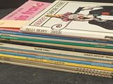 many books stacked on top of each other on a table