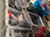 many different types of plumbing pipes and fittings in the bins