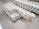several pieces of metal sitting on top of a wooden pallet