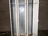 three lockers in the middle of a room with a door open