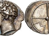 a silver coin with an image of a man ' s head and a cross on it