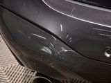 a close up of a car ' s rear end with a dent in it