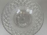 a clear glass bowl with a decorative design on it