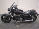 a black motorcycle that is parked in a garage