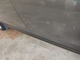 a car that has been painted black and is parked in a garage