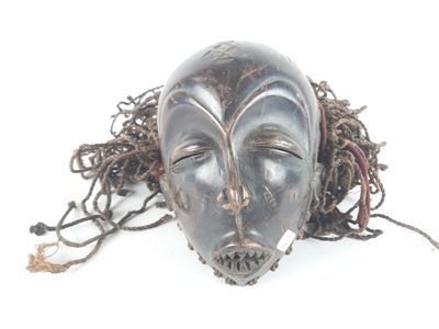 a black mask with dreads on it on a white surface