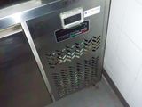 a stainless steel oven sitting in the corner of a kitchen
