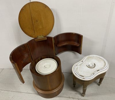 a toilet with a wooden seat next to a wooden stool