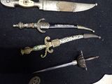 several different types of knives are displayed on a black surface