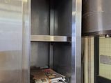 a metal cabinet with a bunch of books inside of it