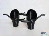 two black cups that are sitting on a table