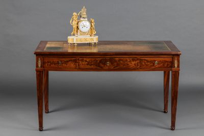 a small table with a clock on top of it