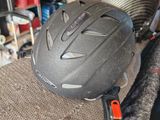 a helmet sitting on top of a chair in a room