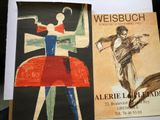 two posters on a table with a woman in a red dress and a man in a red dress