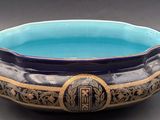 a blue bowl with a gold rim on a table