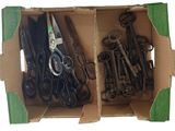 many pairs of scissors in a box on a white background