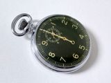 a close up of a pocket watch on a white surface