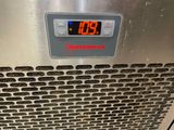 a digital clock on the side of a stainless steel oven