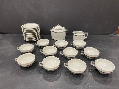 a lot of cups and saucers sitting on a table