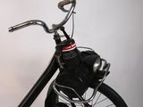 a black scooter with a black seat and a black handlebar