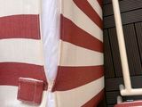 a red and white striped bag sitting on top of a chair