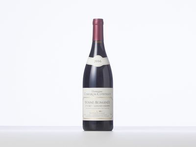 the bottle of red wine is sitting on the table