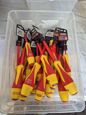 a bunch of tools in a plastic container on a table